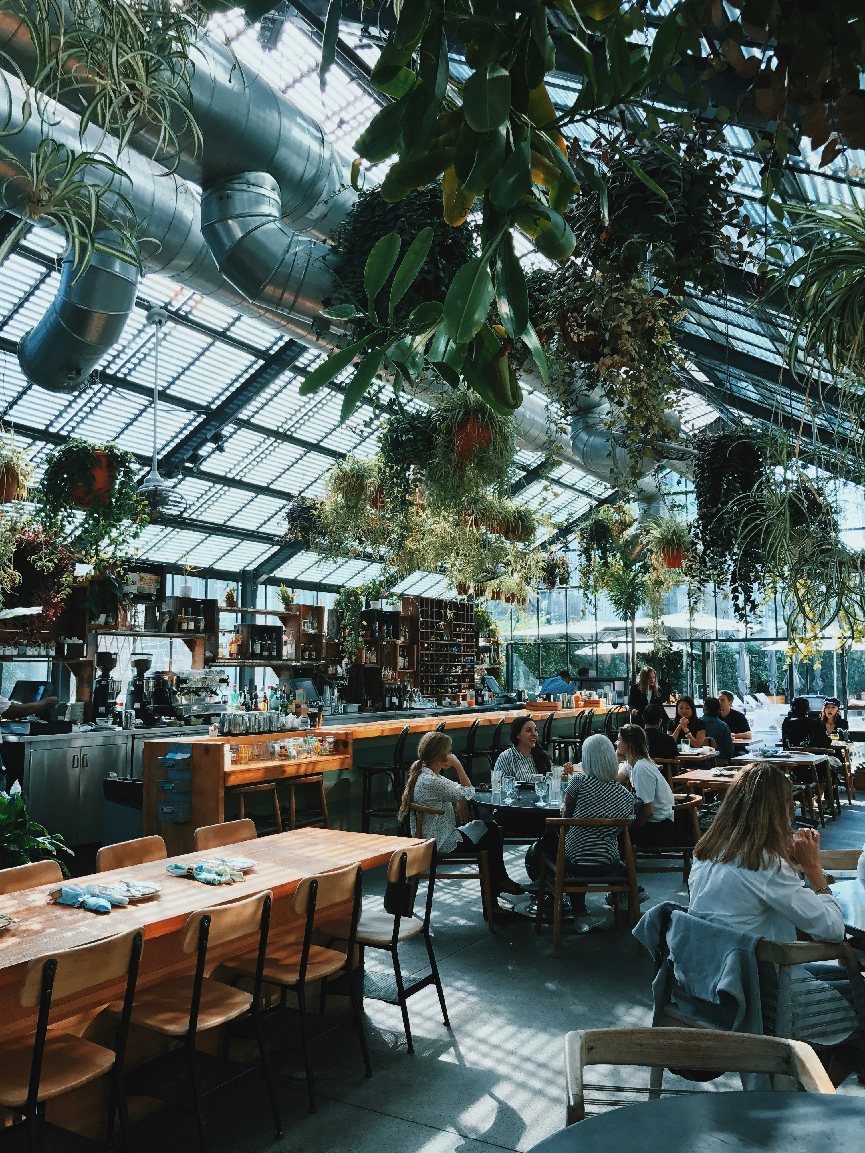 Guests dining together inside the Commissary Restaurant in Los Angeles